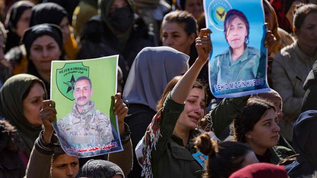 People hold portraits at the funeral of two fighters of the Kurdish-led Syrian Democratic Forces (SDF) who were killed during clashes with Turkish-backed opposition factions last week in northeastern Syria. Picture: AFP