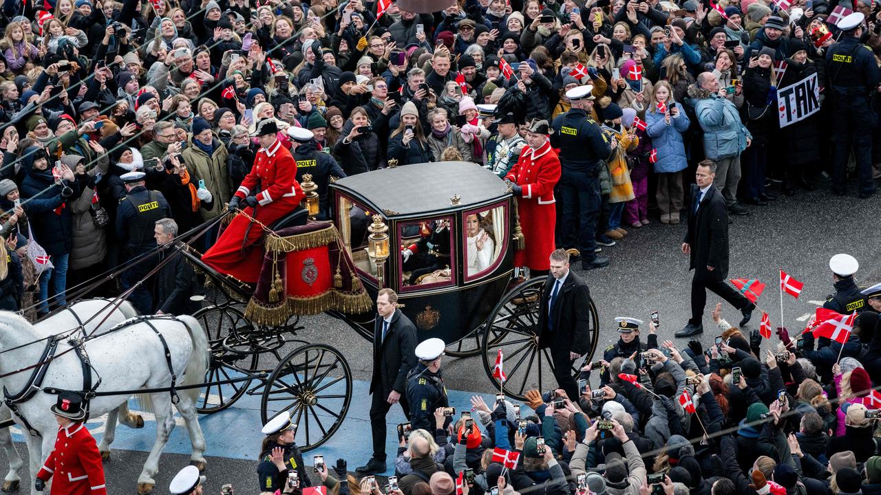 King Frederik X of Denmark and Queen Mary of Denmark ride in a coach past the the crowd of wellwishers back to Amalienborg Palace after a declaration of the King's accession to the throne, from the balcony of Christiansborg Palace in Copenhagen, Denmark on January 14, 2024. Denmark turned a page in its history on January 14 as Queen Margrethe II abdicated the throne and her son became King Frederik X, with more than 100,000 Danes turning out for the unprecedented event. (Photo by Ida Marie Odgaard / Ritzau Scanpix / AFP) / Denmark OUT