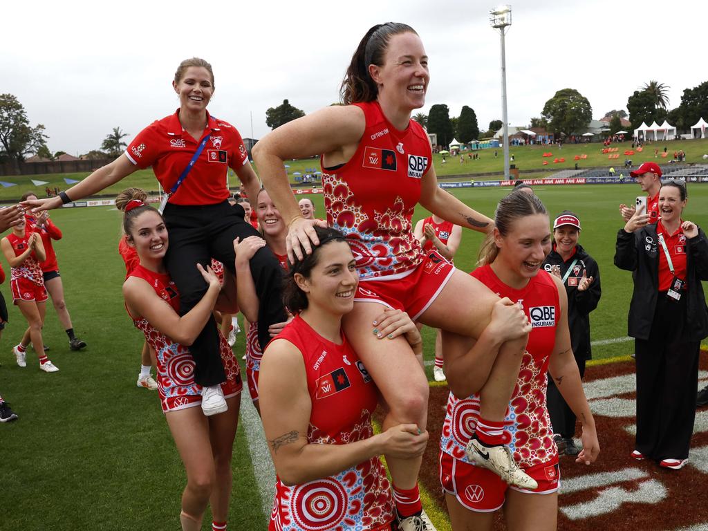 Brooke Lochland and Alana Woodward of the Swans are chaired off their last game. Picture: Phil Hillyard