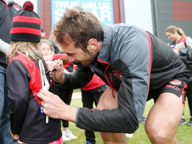 Jobe Watson signs a young fan’s jumper after training. Picture: Michael Klein