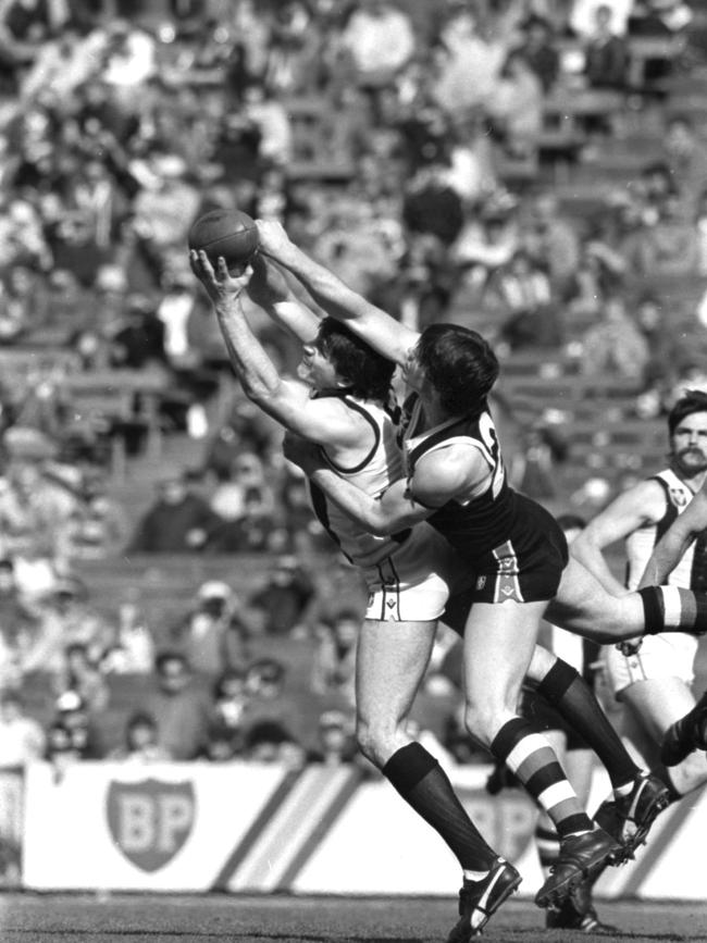 Collingwood forward Brian Taylor lunges foward for a mark against St Kilda's Danny Frawley. Brian Taylor kicked his 100th goal for the season during the game.