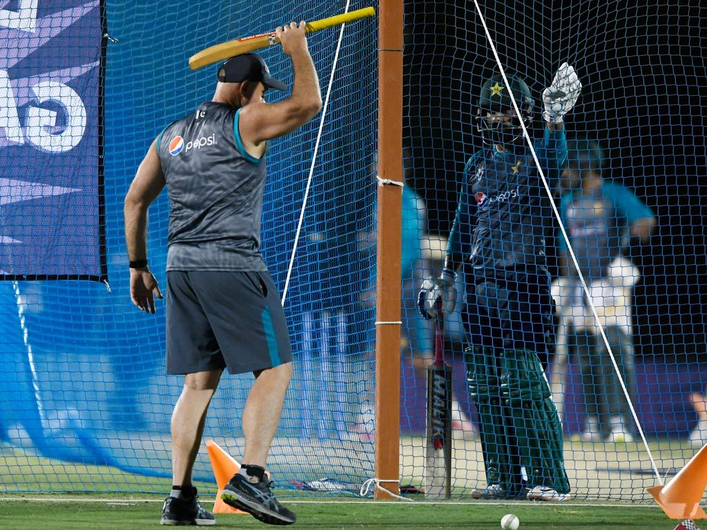 Matthew Hayden, who has been employed as a batting consultant by Pakistan, talks to Mohammad Hafeez (R) in the nets. Aamir Qureshi/AFP