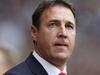 FILE - This is a Saturday, Aug. 17, 2013 file photo of the then Cardiff City's manager Malky Mackay as he looks on from the dugout before the start of their English Premier League soccer match against West Ham United at Upton Park, London. The English Football Association siad Thursday Aug. 21, 2014 that it has opened an investigation after Cardiff submitted a dossier to the governing body about the conduct of former manager Malky Mackay and a member of his backroom staff. (AP Photo/Sang Tan/ File)