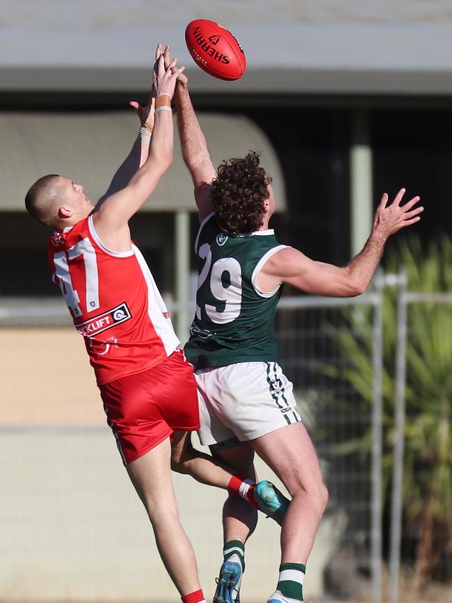 Shepparton Swans’ Harper Simpson soars over Echuca’s Riley Smith.