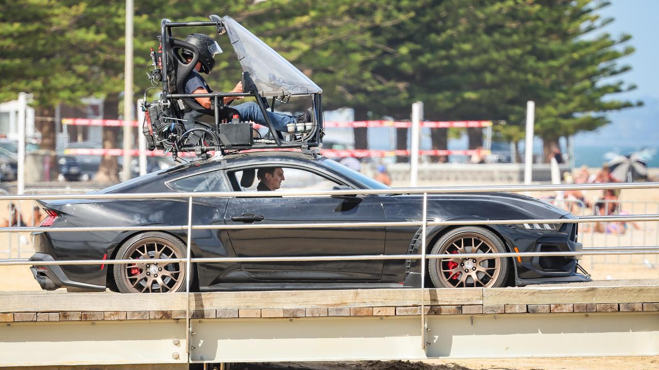 Liam Neeson barrels down Altona Pier in Mustang for The Mongoose