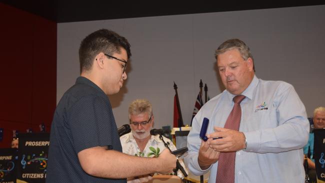 Airlie Beach/Proserpine Young Citizen of the Year Aiden Payet accepts his award from Mayor Andrew Willcox at the Australia Day Awards Ceremony. Photo: Elyse Wurm