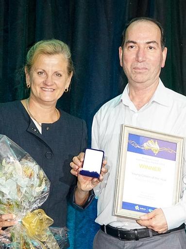 Young citizen Madina Mohmood was continuing her good work overseas and unable to attend the ceremony, so her father stepped up to accept the award from Mayor Karen Williams. Picture: Redland City Council.