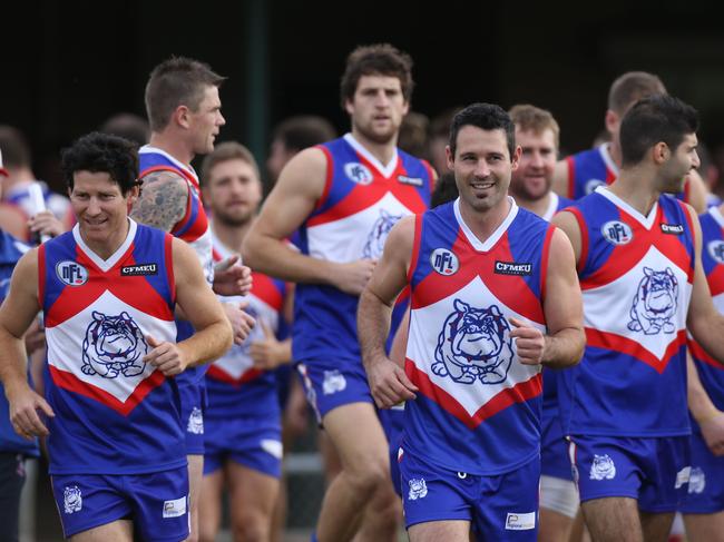 Former Magpie Alan Didak leads North Heidelberg on to the field on Saturday.