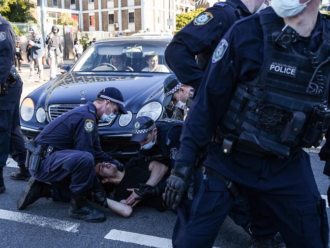 Police detain a man during the protest. Picture: NCA NewsWire/Flavio Brancaleone
