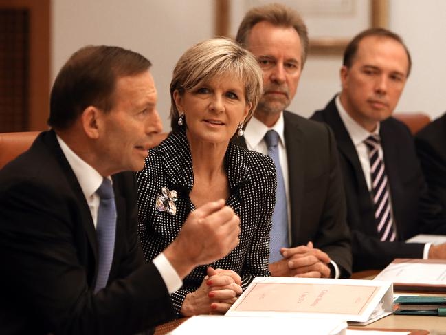 Foreign Affairs Minister Julie Bishop listening to PM Tony Abbott addressing a Cabinet meeting at Parliament House in Canberra.