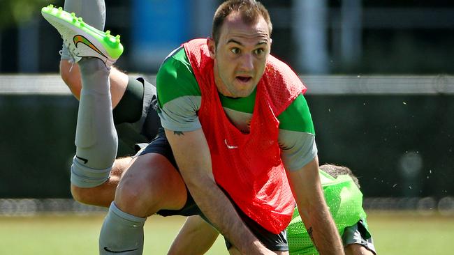 Socceroos training at Olympic Park, Ivan Franjic makes a sliding tackle on Matt McKay at training. Melbourne. 3rd January 2015. Picture: Colleen Petch.