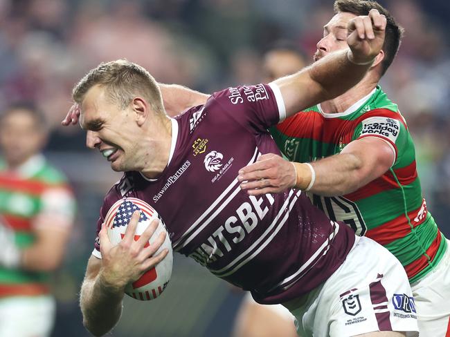 Manly fullback Tom Trbojevic tries to beat a Damien Cook tackle. Picture: Getty Images