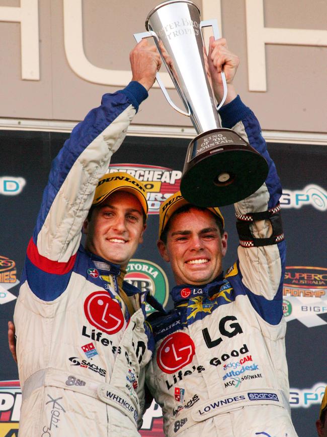 Jamie Whincup (L) and Craig Lowndes on the podium with the Peter Brock trophy after winning 2006 Bathurst 1000 race at Mt Panorama in Bathurst.