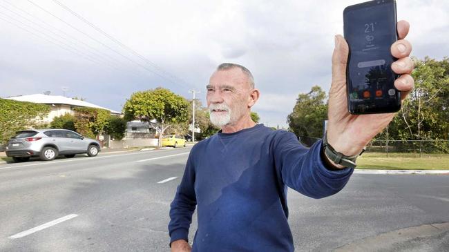 Gregg Miller with his mobile phone looking for coverage in Pottsville. Picture: Scott Powick