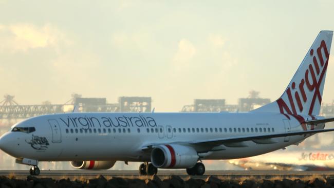 Jetstar & Virgin aircraft on Sydney airport runway ready for take off .pic john Grainger