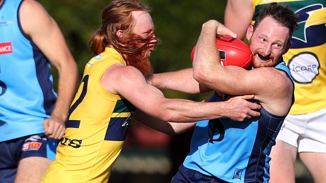 Sturt’s Aidan Riley tries to break the Angus Poole tackle. Picture: Tait Schmaal.