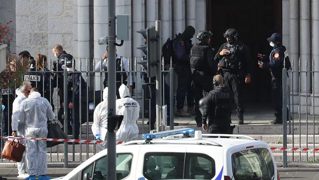 French members of the elite tactical police unit RAID enter to search the Basilica of Notre-Dame de Nice after the knife attack. Picture: AFP