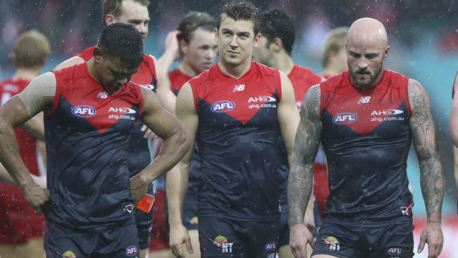 Disappointed Melbourne players Neville Jetta, Jack Trengove and captain Nathan Jones leave the SCG after the loss to the Swans. Picture: Getty