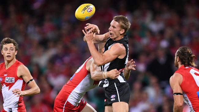 Josh Smith gets a handball out despite being tackled by Sam Reid. Picture: AAP