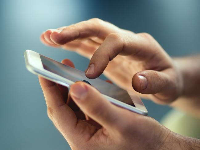 Male hands typing on smartphone. Picture: Istock