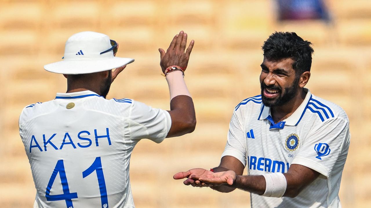 India's Jasprit Bumrah (R) celebrates with Akash Deep after taking the wicket of Bangladesh's Taskin Ahmed during the second day of the first Test