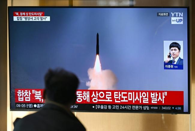 A man watches a news broadcast with file footage of a North Korean missile test at a train station in Seoul