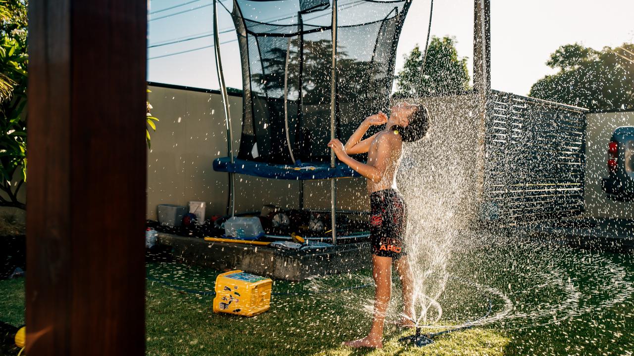 1ST PRIZE: The winning snap captured a young boy enjoying a summer backyard sprinkler shower. Picture: Melissa Crisa