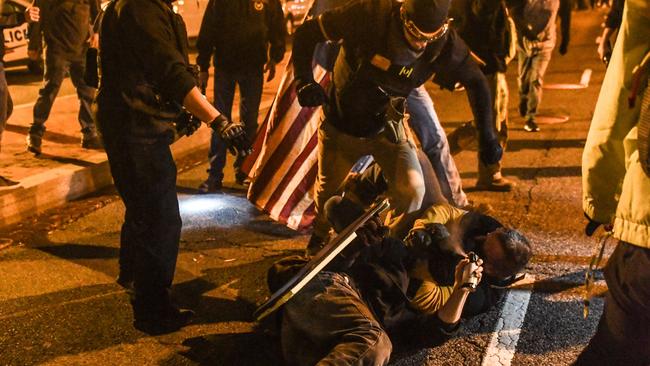 Members of the Proud Boys kick a member of Antifa on the ground during a protest on December 12, 2020 in Washington, DC. Picture: Stephanie Keith/Getty Images/AFP