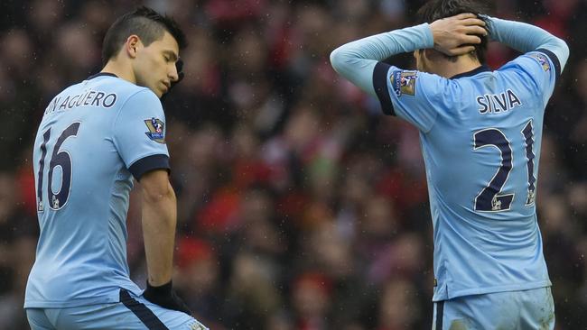 Manchester City's Sergio Aguero, left, and David Silva wait for play to restart after a goal by Liverpool's Philippe Coutinho during the English Premier League soccer match between Liverpool and Manchester City at Anfield Stadium, Liverpool, England, Sunday, March 1, 2015. Liverpool won the match 2-1. (AP Photo/Jon Super)