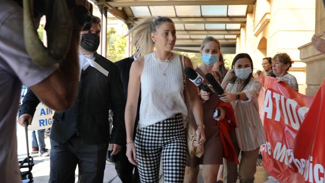 Anti-vaxxers applaud Deni Varnhagen as she arrives for day three of her vaccine mandate trial in April. Picture: Dean Martin