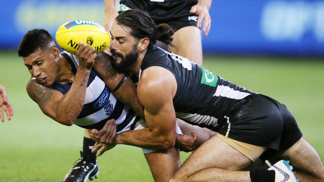 Brodie Grundy lays a crunching tackle on Geelong’s Tim Kelly. Picture: Michael Klein