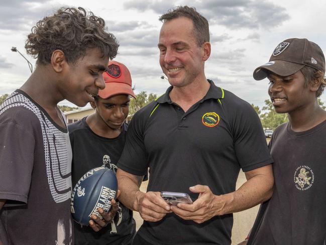 26/04/2023: Alice Springs based Yipirinya School principal Gavin Morris with students on the school grounds. Malikai Hayes, Keylin Peters (red cap), Adrian Nelson (black cap) & Jahquille Stuart (rat tail). PIC: Grenville Turner