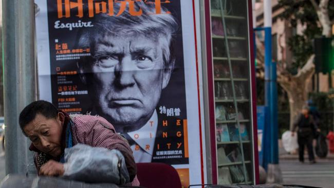 Trump, pictured here on a newspaper poster, is big news in China. Picture: AFP