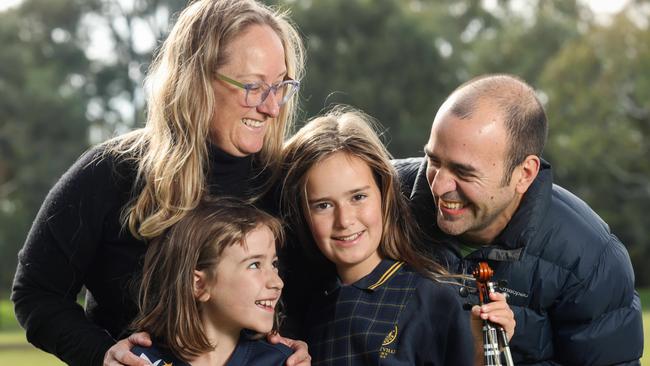 Sports-mad sisters Anna and Sofia, with parents Kathy and Gerado. Picture: Russell Millard