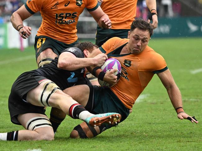 Australia’s Hayden Sargeant is tackled by Canada’s Phil Berna in their Pool A match at the 2024 Rugby Sevens Hong Kong tournament at the Hong Kong stadium on April 6, 2024. (Photo by Peter PARKS / AFP)