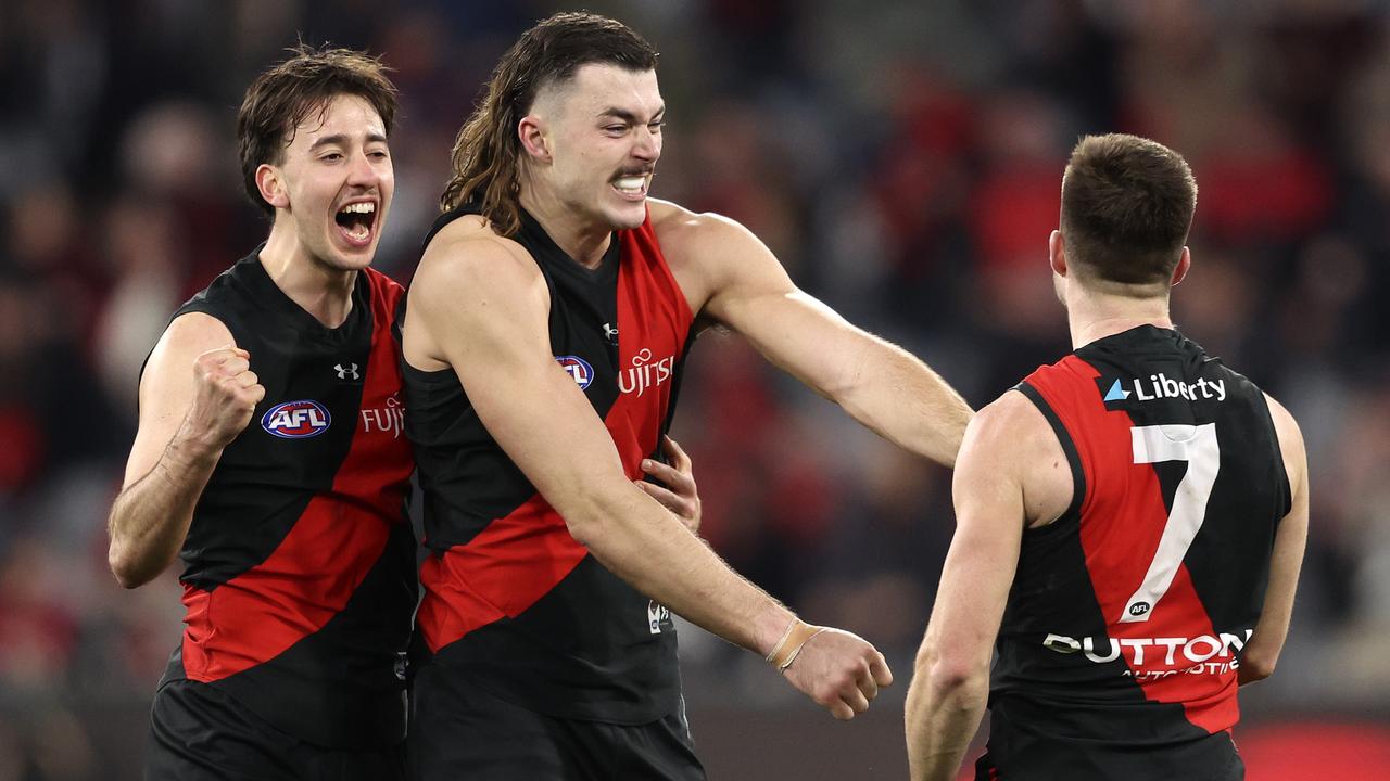 MELBOURNE, AUSTRALIA - AUGUST 04: Nic Martin, Sam Draper and Zach Merrett of the Bombers celebrate their win during the round 21 AFL match between Essendon Bombers and Fremantle Dockers at Melbourne Cricket Ground, on August 04, 2024, in Melbourne, Australia. (Photo by Martin Keep/AFL Photos/via Getty Images)