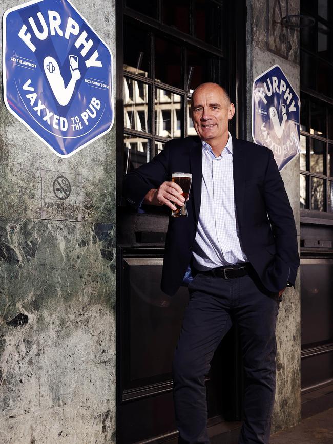 DAILY TELEGRAPH - Pictured is Lion Nathan MD James Brindley outside the Grand Hotel in Sydney today, holding a schooner of Furphy to announce the Vax initiative. Picture: Tim Hunter.