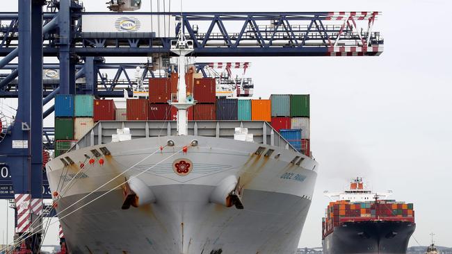 Workers on the docks at Port Botany continue to unload containers from the ships docked at the wharf today. Picture: Toby Zerna