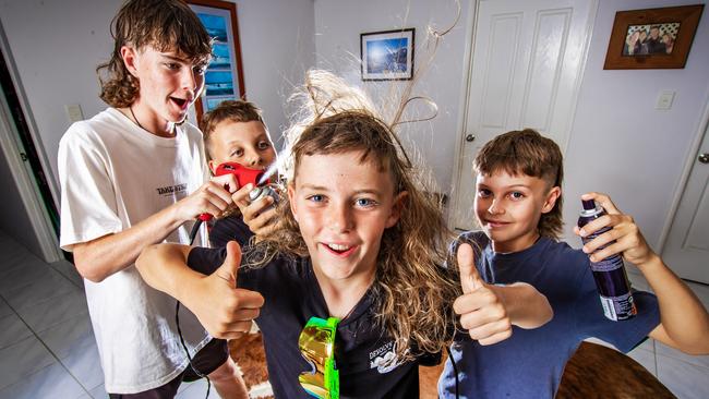 Elijah Gunn, 8, celebrates winning the best mullet with his siblings Kayden, 13, Macalister, 15 and Braithan, 10. Picture: Nigel Hallett