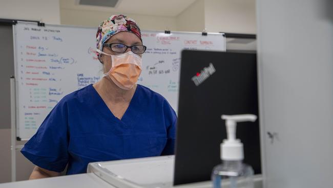 Judy Bradbury processing documents for testing at the clinic. Image Matthew Vasilescu