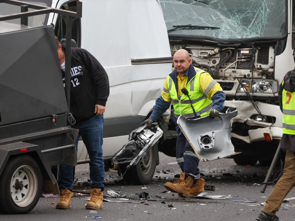 MELBOURNE, AUSTRALIA- JUNE 15 2022, A man cleans up at a Car crash on the Monash near Yarra Bvld involving 3 cars and a truck. Picture: Brendan Beckett