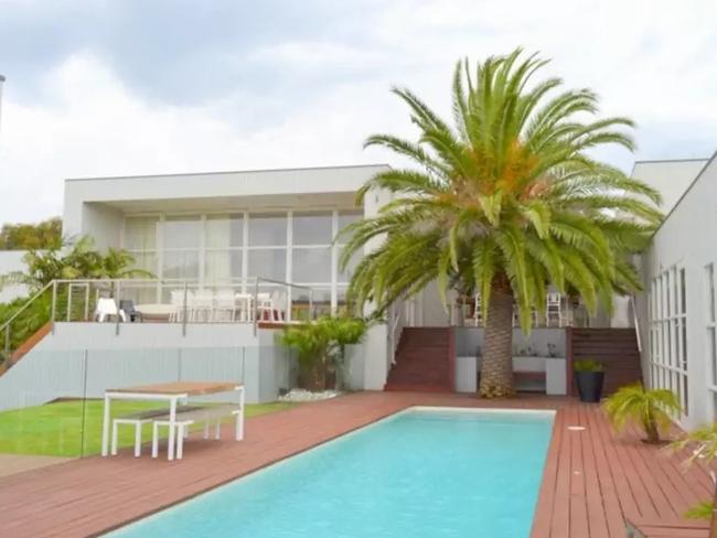 It's got more than one giant deck, a pool and a palm tree — paradise! Picture: Airbnb