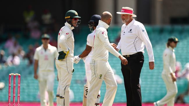 SYDNEY, AUSTRALIA – JANUARY 09: Tim Paine and Nathan Lyon of Australia questions Umpire Paul Wilson over a DRS referral against Cheteshwar Pujara of India during day three of the 3rd Test match in the series between Australia and India at Sydney Cricket Ground on January 09, 2021 in Sydney, Australia. (Photo by Ryan Pierse/Getty Images)