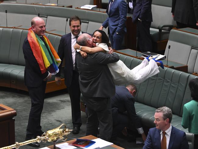 Look away now, Mr and Mrs Jensen. Liberal MP Warren Entsch celebrates with Labor MP Linda Burney. Picture: Lukas Coch/AAP