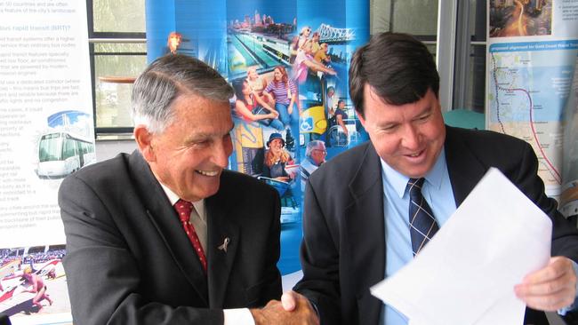 2011: Gold Coast Mayor Ron Clarke and Transport and Main Roads Minister Paul Lucas shake hands after signing a $550 million Memorandum of Understanding for the light rail system.