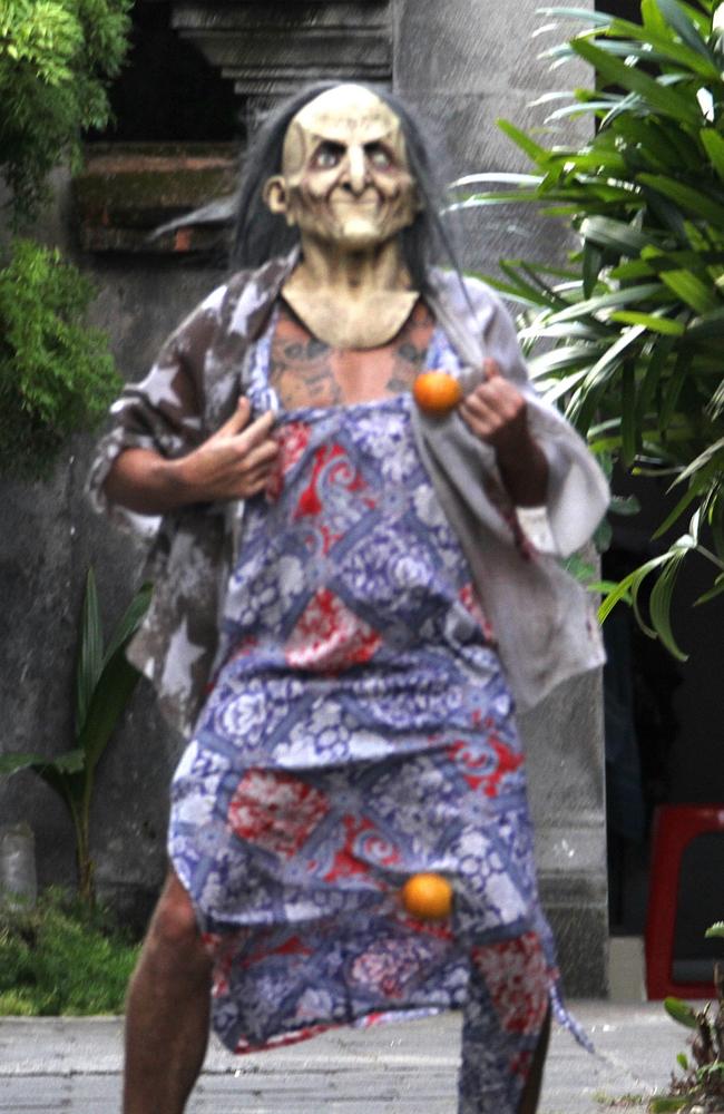 Corby's brother Michael pulls oranges from under his dress, while wearing a weird zombie mask outside his sister’s home in Bali. Picture: Supplied.