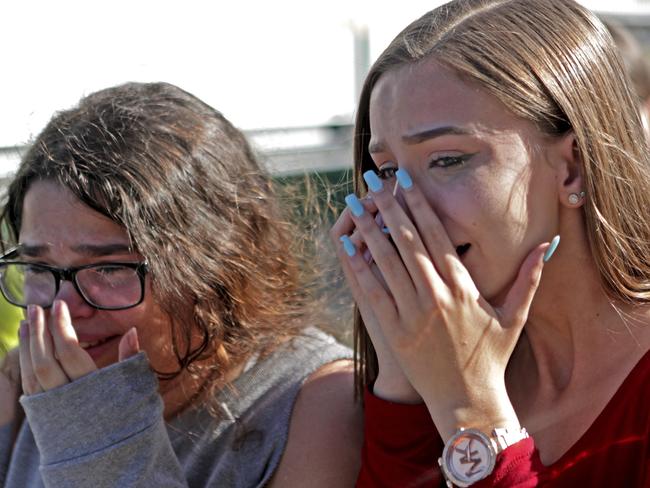 Students released from a lockdown are overcome with emotion following a shooting at Marjory Stoneman Douglas High School. Picture: AP
