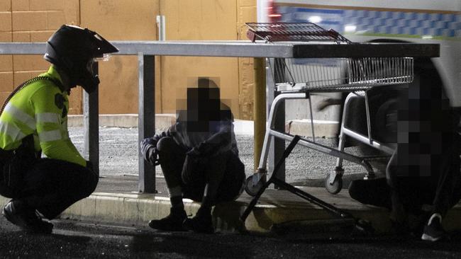 A police officer checks on a young boy. Picture: Liam Mendes