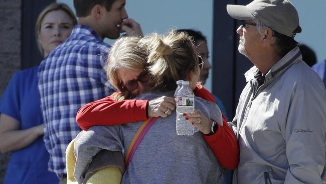 Two women embrace outside of a family assistance centre in Las Vegas. The makeshift centre was set up to help families and others reconnect after the mass shooting.