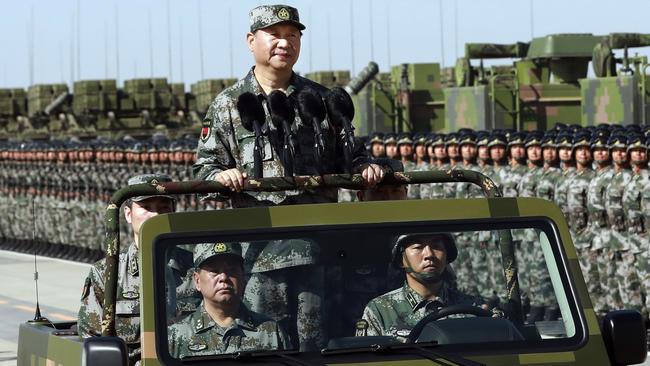 Chinese President Xi Jinping stands on a military jeep as he inspects troops of the People's Liberation Army during a military parade. Picture: AP